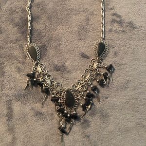 Silver necklace with black dangly pendants